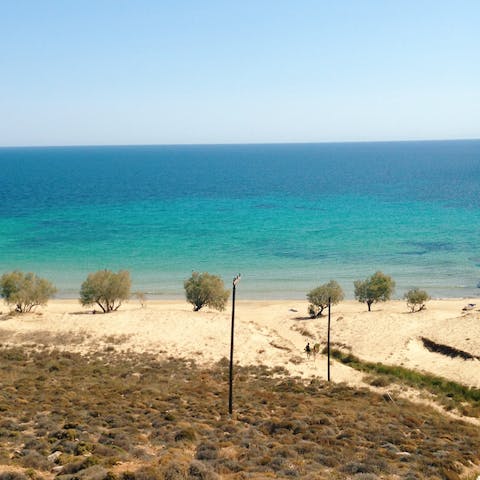 Take a seven-minute stroll down to Psarou Beach for a day on the sand