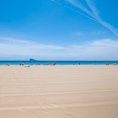 Sink your feet into the sand at Levante beach, just 150m away