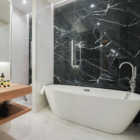 Have a soak in the freestanding bathtub after a busy day in Madrid