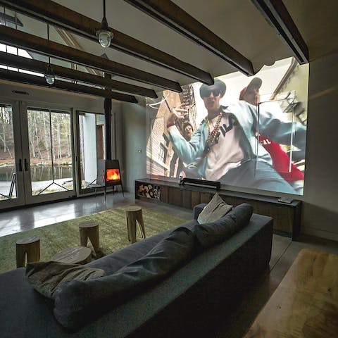 Have a cosy film night with the projector and wood stove in the living area