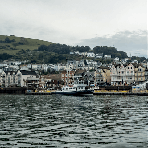 Watch the boats sailing down the River Dart