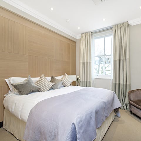 Wake up to leafy Kensington views in your elegant bedroom