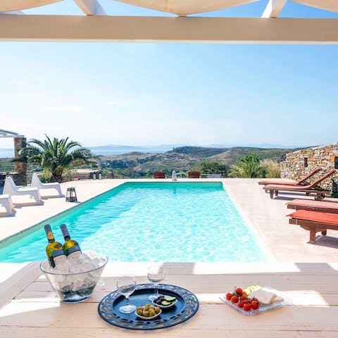 Lounge by the pool and admire the stunning views of the Aegean Sea