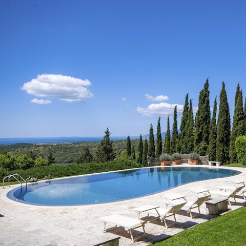 Admire the countryside and sea views from the edge of the infinity pool