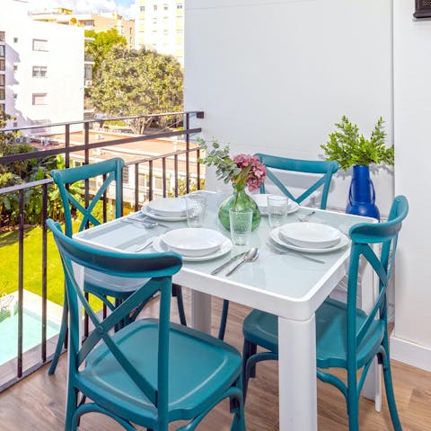 Share an alfresco supper on the private balcony overlooking the pool