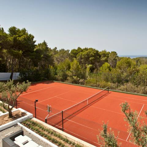 Play a game of tennis on the home's court