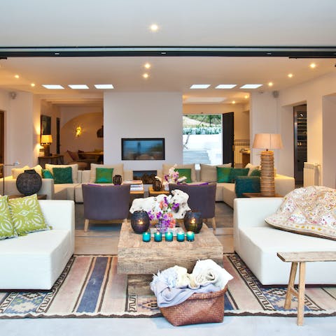 Cuddle around the electric fire in the spacious living area