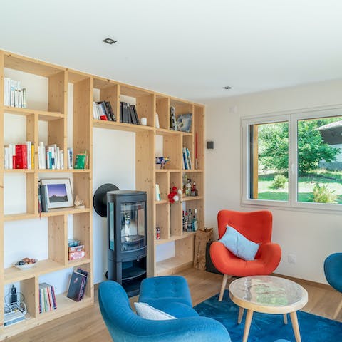 Return to a cheery living space offering a bookcase and a cosy log burner