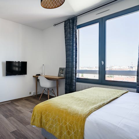 Wake up to views of the Parisian skyline from the bedroom's huge window