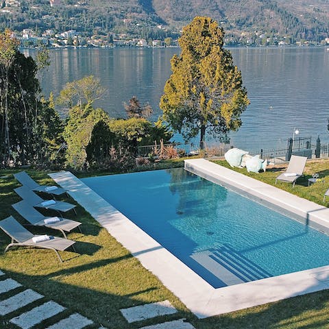 Relax on a sun lounger by the pool with a cocktail in hand