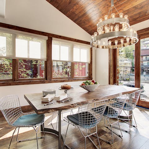 Enjoy a decadent dinner under the modern chandelier