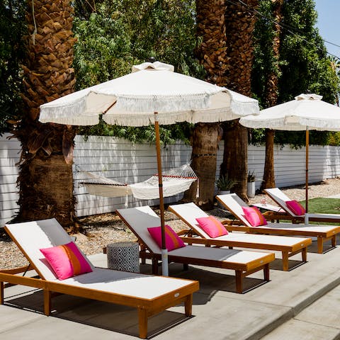 Relax on the sun loungers around the swimming pool 