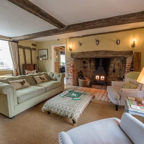 Cosy up in the living room in front of one of the home's wood-burning stoves