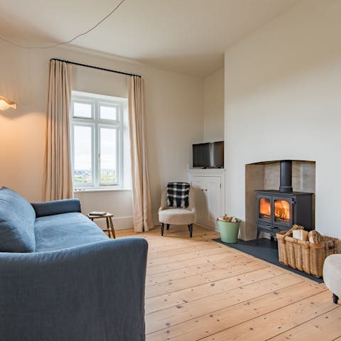 Cosy up with a cup of tea in front of the wood-burning stove
