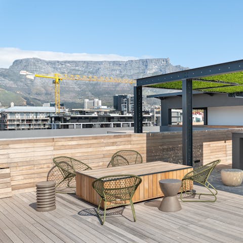 Enjoy a sundowner on the communal terrace while feasting on views of Table Mountain