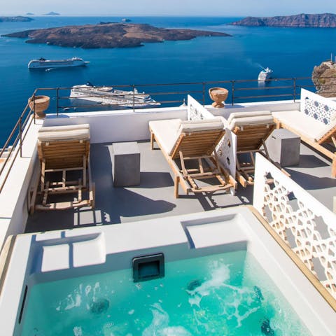 Take in the beguiling views of the caldera from the private hot tub 