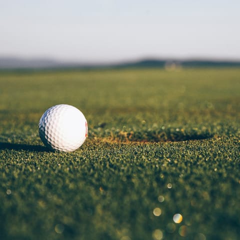Practice your swing at the nearby golf course 