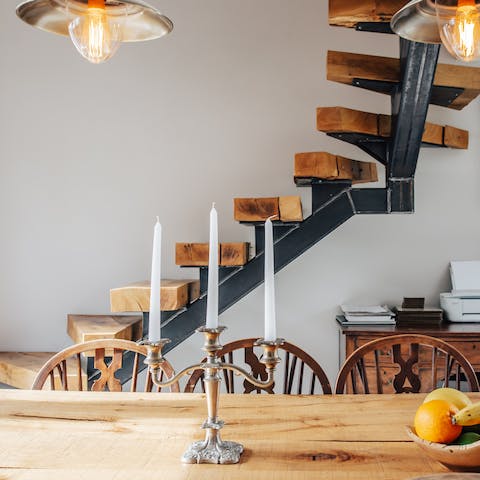An oak floating staircase to a bedroom above the kitchen