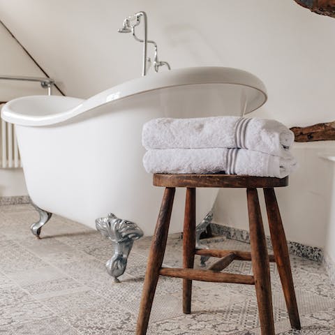 The elegant roll-top bath in the master bedroom