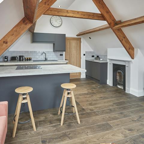 Take in the original features of this home, including a cast iron fireplace and exposed wooden beams
