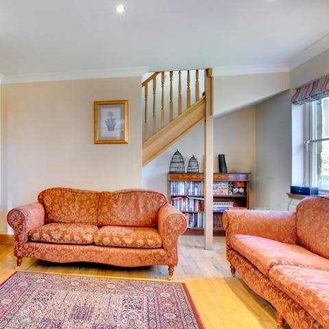 Put your feet up in a traditional sitting room after walking back from the village pub
