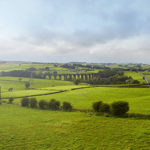 Walk across fields and fells for fifteen minutes to the dramatic picture of Hewenden Viaduct
