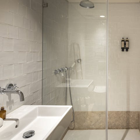 Relax under the bathroom's rainfall shower before setting off for a day of exploring