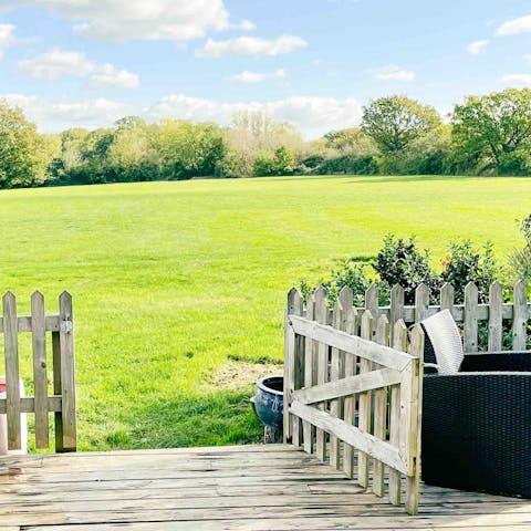Step straight out onto a huge open field from your private decking area 