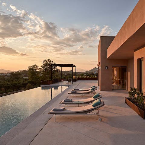 Watch the sunset over the bay from beside the private pool