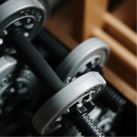 Lift dumbbells in the fully equipped, on-site gym