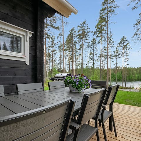 Appreciate the serenity of your surroundings on the deck, perfect for dining under the stars
