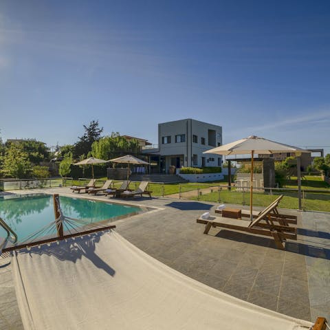 Relax by the pool in the hammock or on a sun lounger