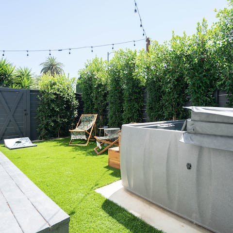 Unwind in the private hot tub in the garden with a glass of bubbly