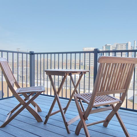 Enjoy a cool drink on the private balcony at the end of a long day exploring the city