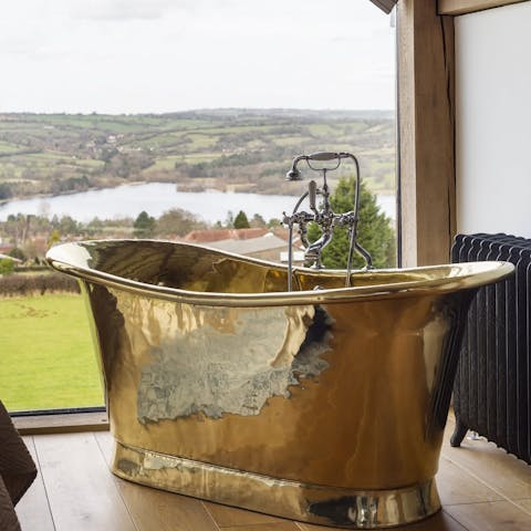 Soak in the brass bath and drink in the countryside views