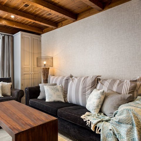 Get cosy beneath the throws on the plush sofa after a long day on the slopes