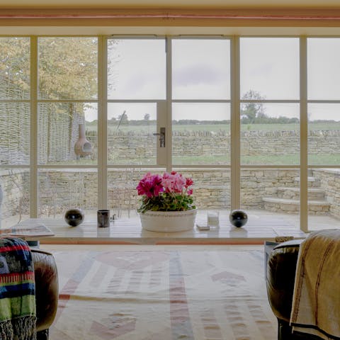 Enjoy a hot cup of coffee in the living room and admire views of the garden
