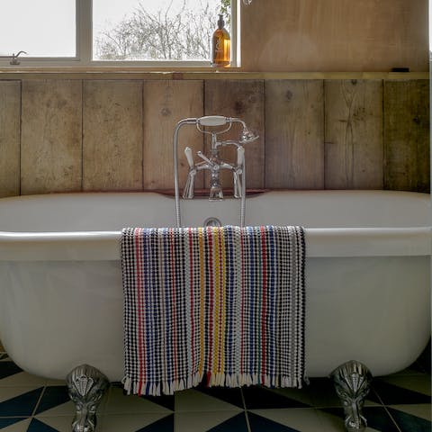 Unwind after a day of walking in the countryside in the roll top bath