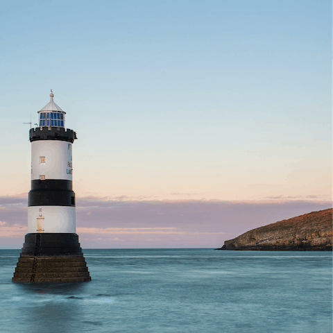 Visit Penmon Lighthouse and the nearby Beaumaris Castle on Anglesey's east coast, a little over half an hour away