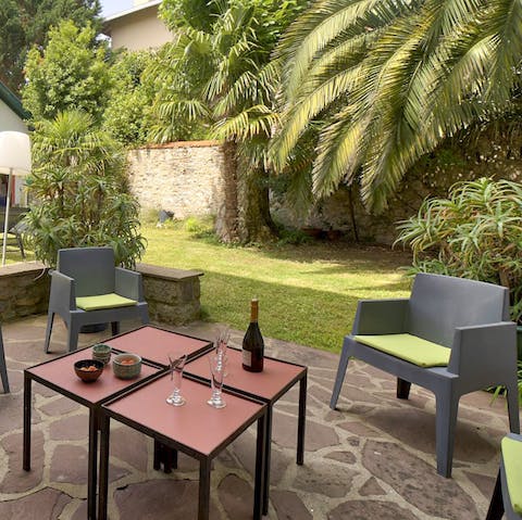 Share an aperitif of French wine and cheese at the patio lounge area 