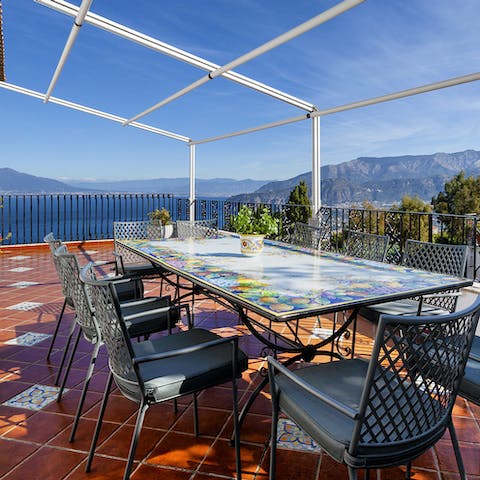 Eat outside on the dining terrace with views of the bay and the surrounding mountains