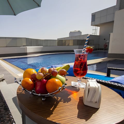 Sip a refreshing drink by the communal pool