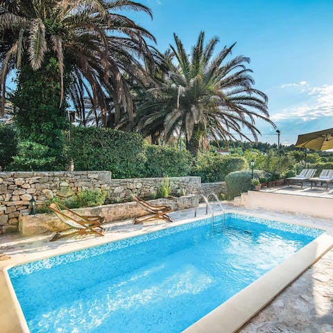 Relax in the beautiful pool surrounded by gardens