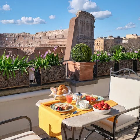 Dig into a delicious alfresco breakfast while admiring the Colosseum views 