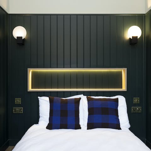 Get some rest in the bedroom with its navy panelling after a busy day in Edinburgh