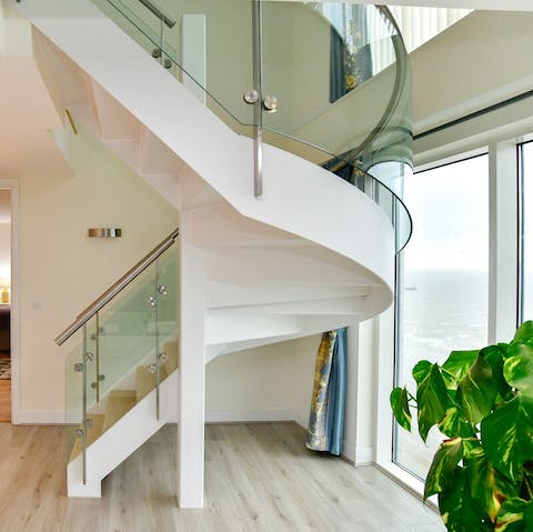 Enjoy the ample space of this luxurious penthouse, benefitting from a statement staircase