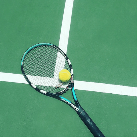 Play a friendly tennis match on the courts