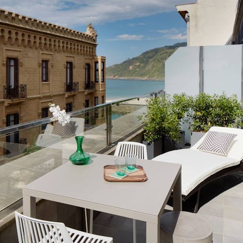 Enjoy sea views and people watching from the sunny balcony