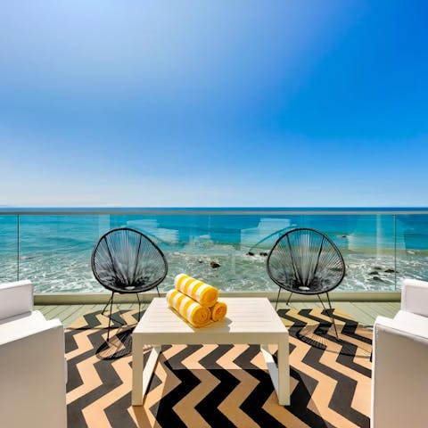 Enjoy drinks overlooking the ocean on your private balcony