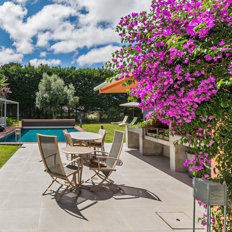 Get your grill on in the professional outdoor kitchen before dining alfresco beside the pool